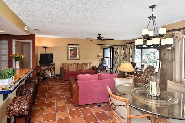 tiled living room with ceiling fan with notable chandelier and a textured ceiling