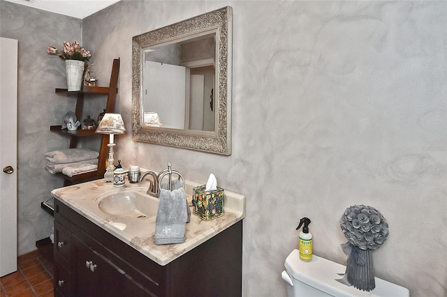 bathroom featuring vanity, toilet, and tile patterned flooring