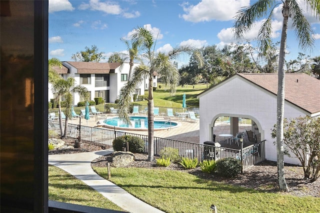 view of swimming pool with a patio and a lawn