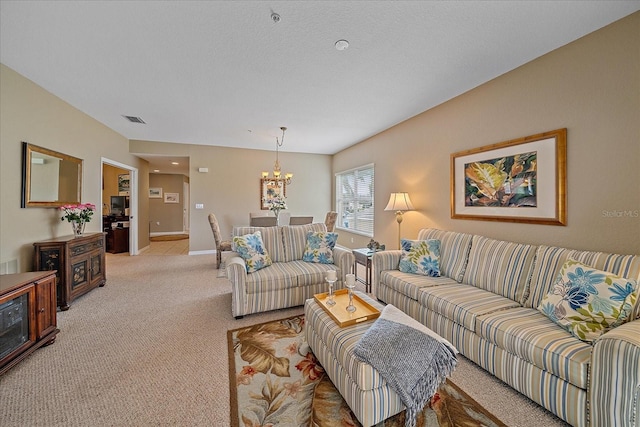 carpeted living room with a textured ceiling and a chandelier