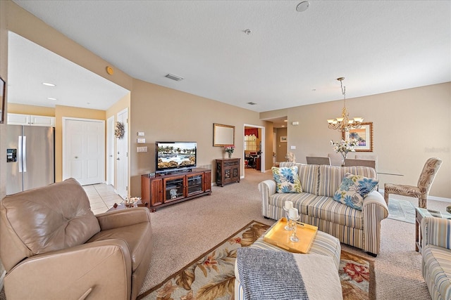 carpeted living room featuring a notable chandelier and a textured ceiling