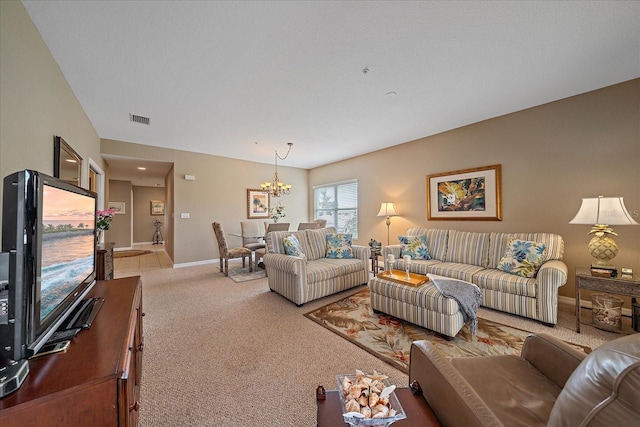 carpeted living room featuring a chandelier