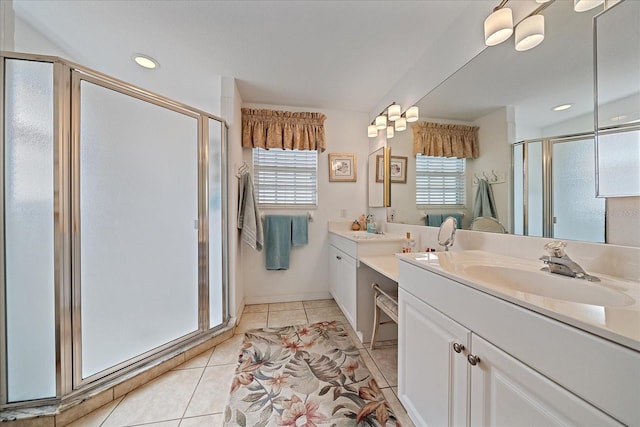 bathroom with vanity, a healthy amount of sunlight, tile patterned floors, and a shower with shower door