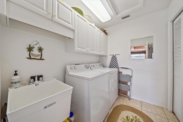 washroom featuring cabinets, light tile patterned flooring, separate washer and dryer, and sink