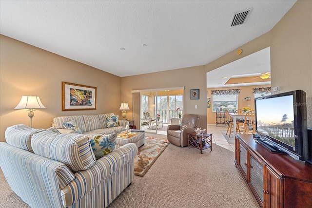 carpeted living room with ceiling fan