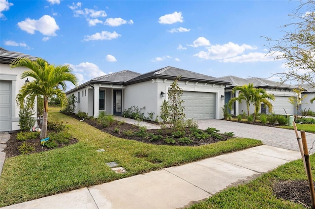 view of front facade featuring a garage and a front lawn