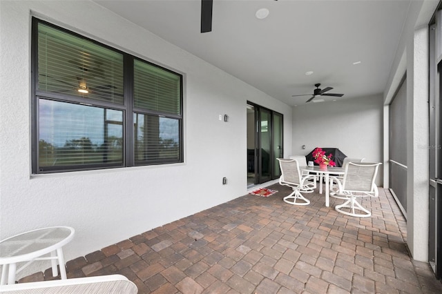 sunroom featuring ceiling fan