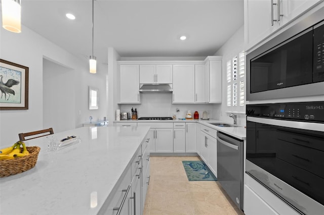 kitchen featuring white cabinetry, hanging light fixtures, sink, and appliances with stainless steel finishes