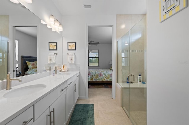 bathroom with ceiling fan, tile patterned floors, an enclosed shower, and vanity