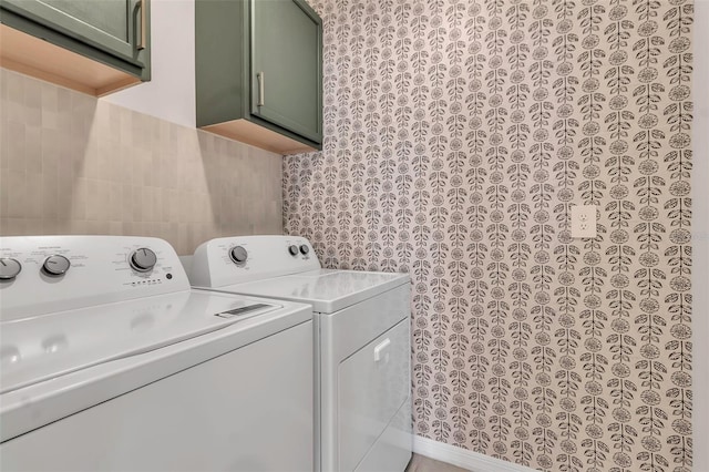 laundry area featuring independent washer and dryer and cabinets