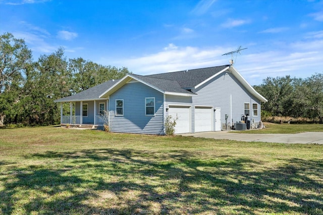 view of front of home featuring a garage, covered porch, and a front yard