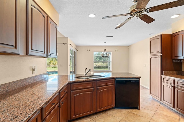 kitchen with stone counters, light tile patterned flooring, decorative light fixtures, dishwasher, and sink