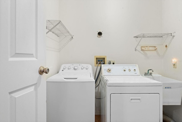 washroom featuring separate washer and dryer and sink