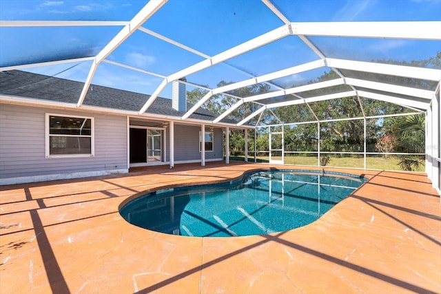 view of swimming pool with a patio and glass enclosure