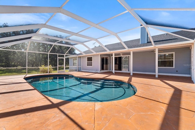 view of pool with ceiling fan, a lanai, and a patio area