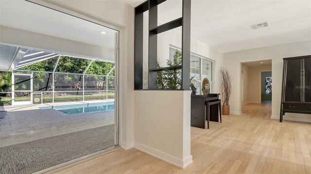 corridor with light hardwood / wood-style floors