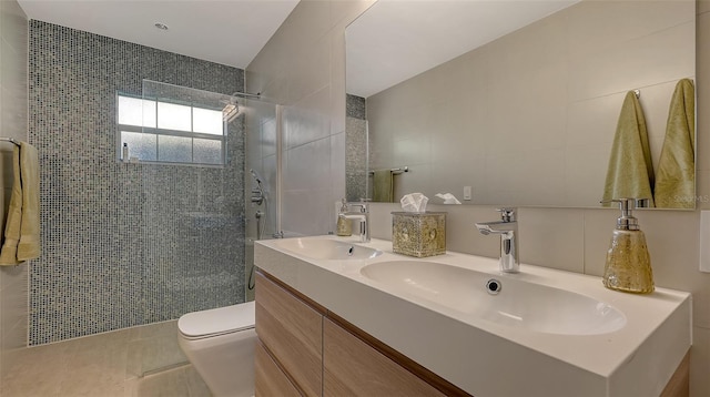 bathroom featuring tile walls, tile patterned flooring, vanity, walk in shower, and toilet