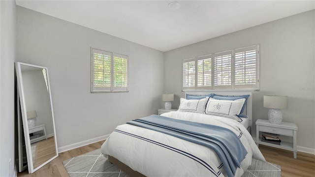 bedroom with hardwood / wood-style floors