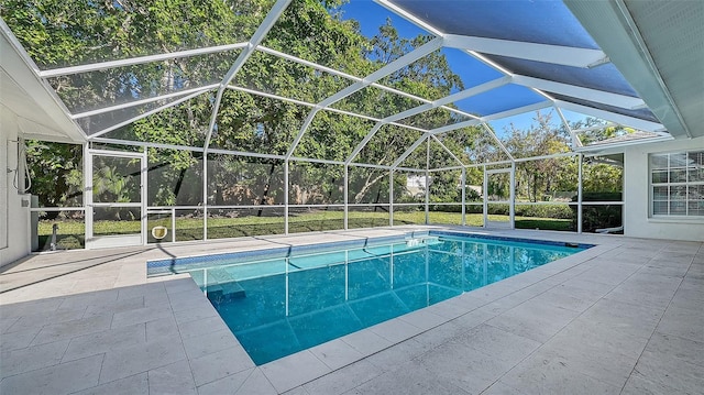 view of swimming pool featuring a patio and glass enclosure