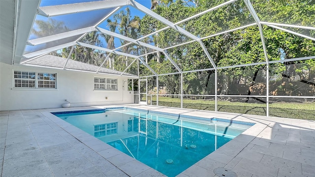 view of swimming pool featuring a lanai and a patio area