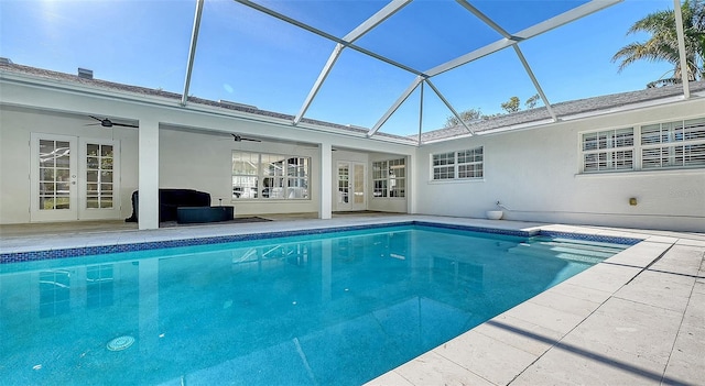 view of swimming pool featuring a patio, french doors, ceiling fan, and glass enclosure