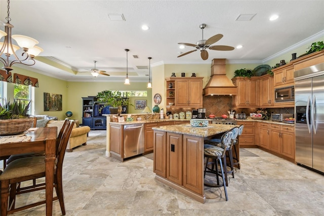 kitchen with custom exhaust hood, built in appliances, kitchen peninsula, a kitchen island, and pendant lighting