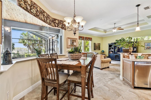 dining area featuring a tray ceiling, ceiling fan with notable chandelier, and ornamental molding