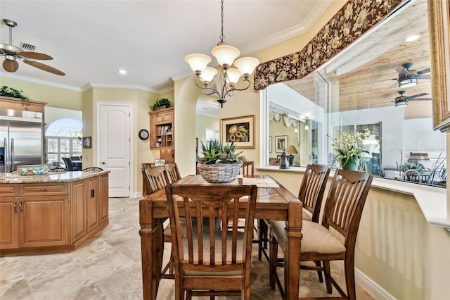 dining space with ornamental molding and ceiling fan with notable chandelier