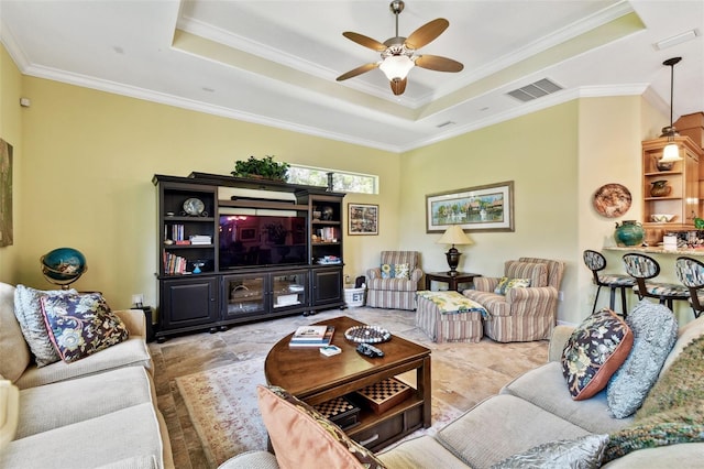 living room with crown molding, ceiling fan, and a raised ceiling