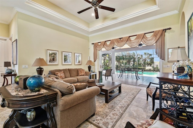 living room with ceiling fan, ornamental molding, and a tray ceiling