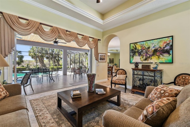 living room with crown molding and a raised ceiling