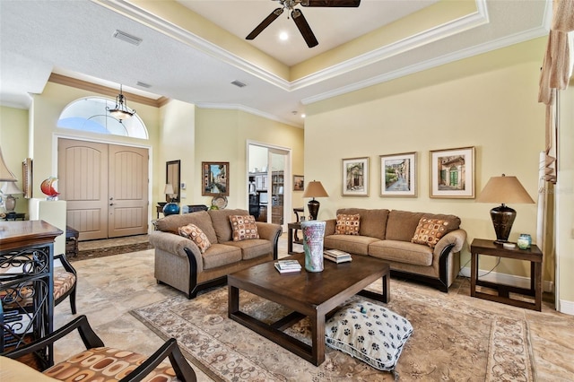 living room featuring crown molding and a raised ceiling