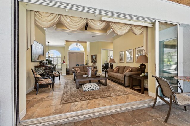 interior space featuring ornamental molding and a notable chandelier