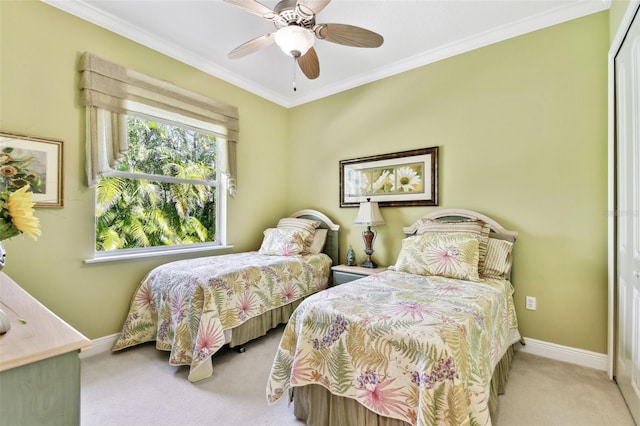 carpeted bedroom with crown molding, ceiling fan, and a closet