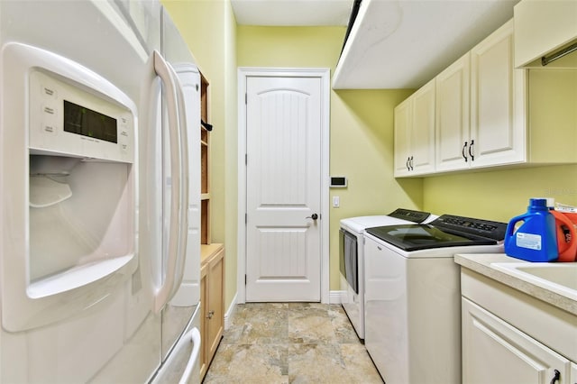 washroom with cabinets and washer and dryer