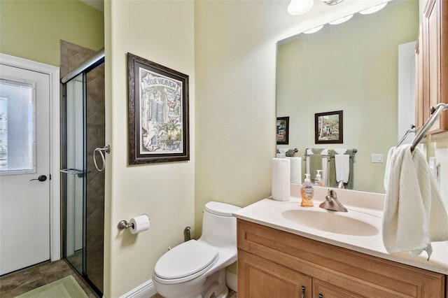 bathroom featuring vanity, toilet, and walk in shower