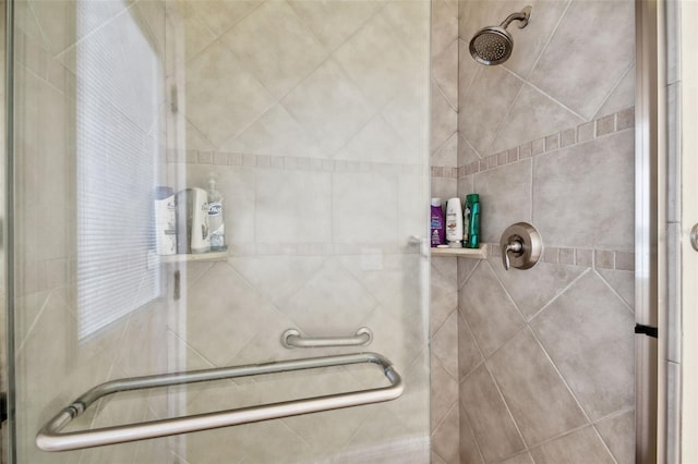 bathroom featuring a shower with shower door