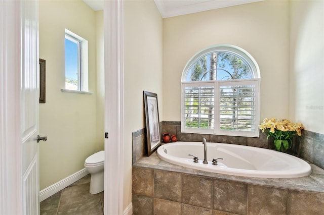 bathroom featuring tiled tub, a wealth of natural light, ornamental molding, and toilet