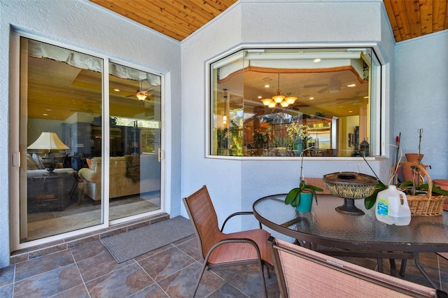 sunroom / solarium with an inviting chandelier and wooden ceiling