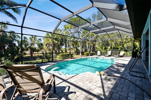 view of pool with a lanai and a patio