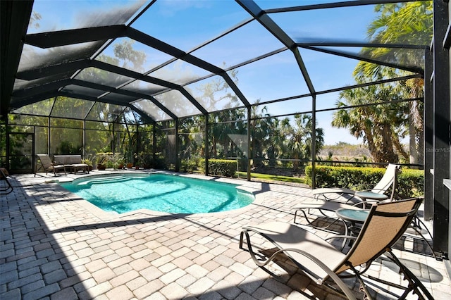 view of swimming pool with a patio and glass enclosure