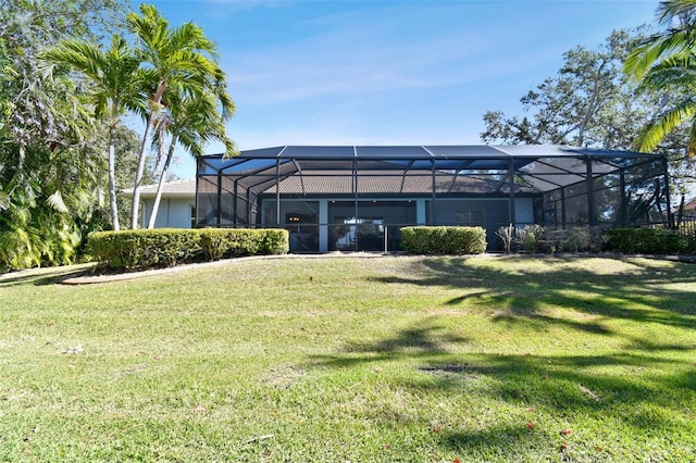 back of property featuring a yard and a lanai