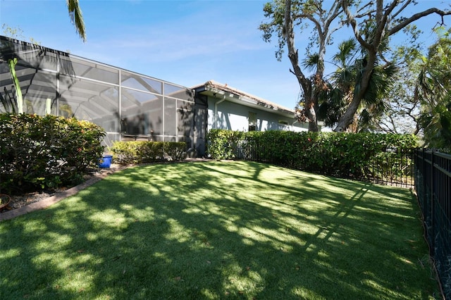 view of yard featuring glass enclosure