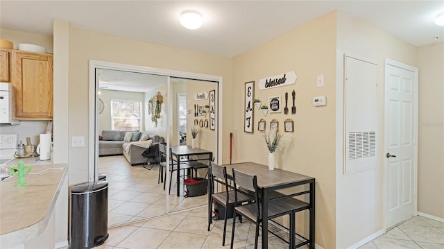 dining space featuring light tile patterned floors