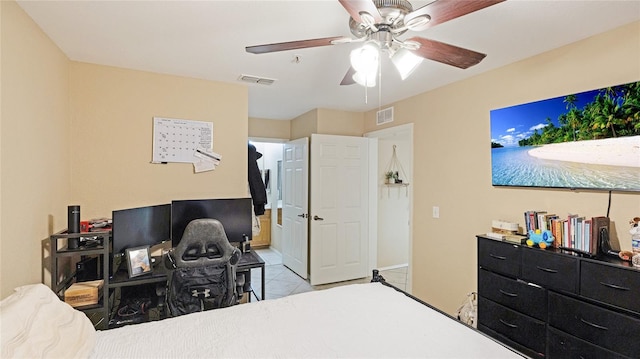 tiled bedroom featuring ceiling fan