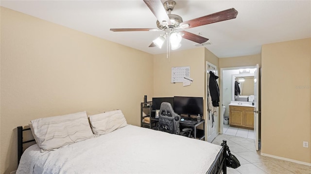 bedroom with ceiling fan, connected bathroom, and light tile patterned floors