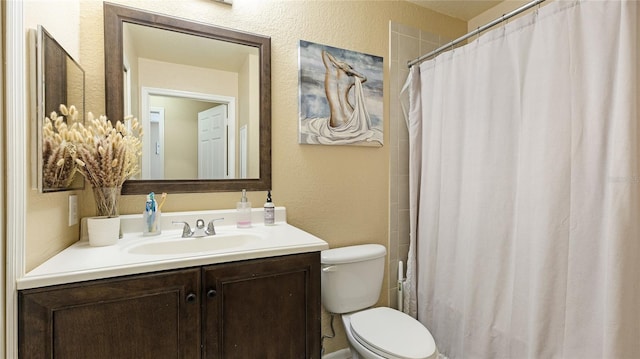 bathroom with vanity, toilet, and a shower with shower curtain