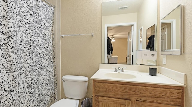 bathroom featuring vanity, a shower with curtain, and toilet