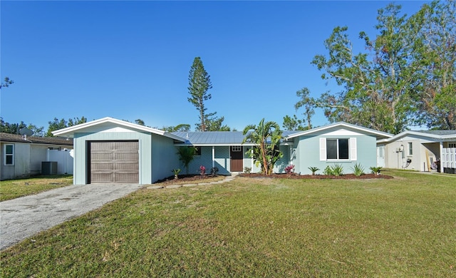 ranch-style home with a garage, central AC unit, and a front lawn