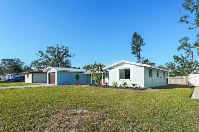 ranch-style house featuring a garage and a front yard